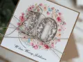 Elegancka kartka z napisem "W dniu Waszego Jubileuszu" i ażurowymi cyframi "10" na tle wianuszka z różowych kwiatów. Idealna na 10 rocznicę ślubu.