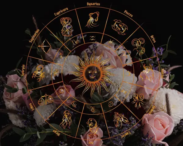 Zodiakalny krąg z symbolami i słońcem na tle bukietu róż. Kwiaty przypisane do miesięcy tworzą mistyczną oprawę.