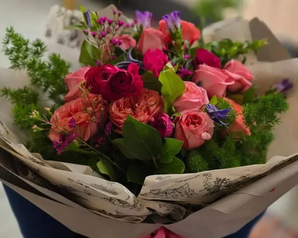 Piękny bukiet róż i innych kwiatów, idealny jako prezent. Jakie kwiaty dla starszej osoby? Te delikatne, pastelowe róże z pewnością ucieszą.