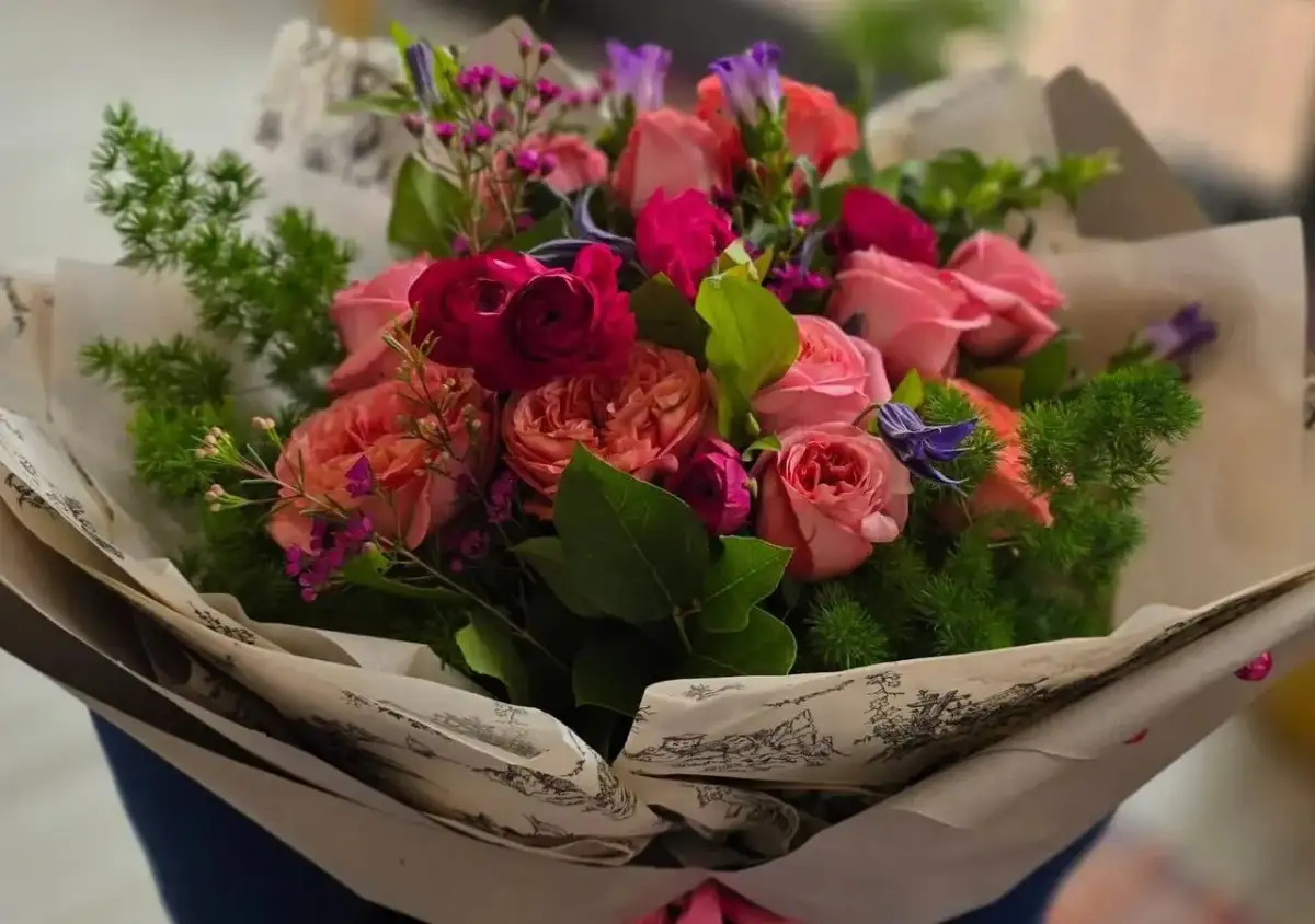 Piękny bukiet róż i innych kwiatów, idealny jako prezent. Jakie kwiaty dla starszej osoby? Te delikatne, pastelowe róże z pewnością ucieszą.